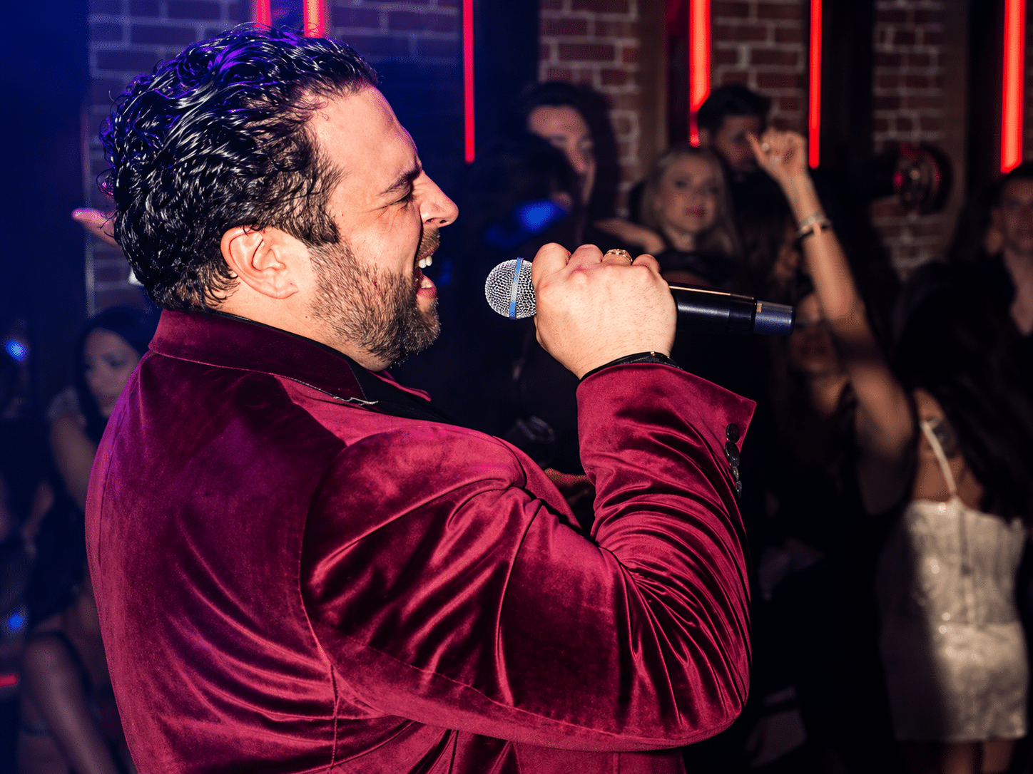 Spotlit karaoke stage with vintage microphone at Gaslamplighter in San Diego's Gaslamp Quarter
